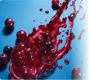 Fresh red fruit (possibly cranberry or other berry) with splashes of red liquid, representing a natural oral health ingredient found in ProvaDent.