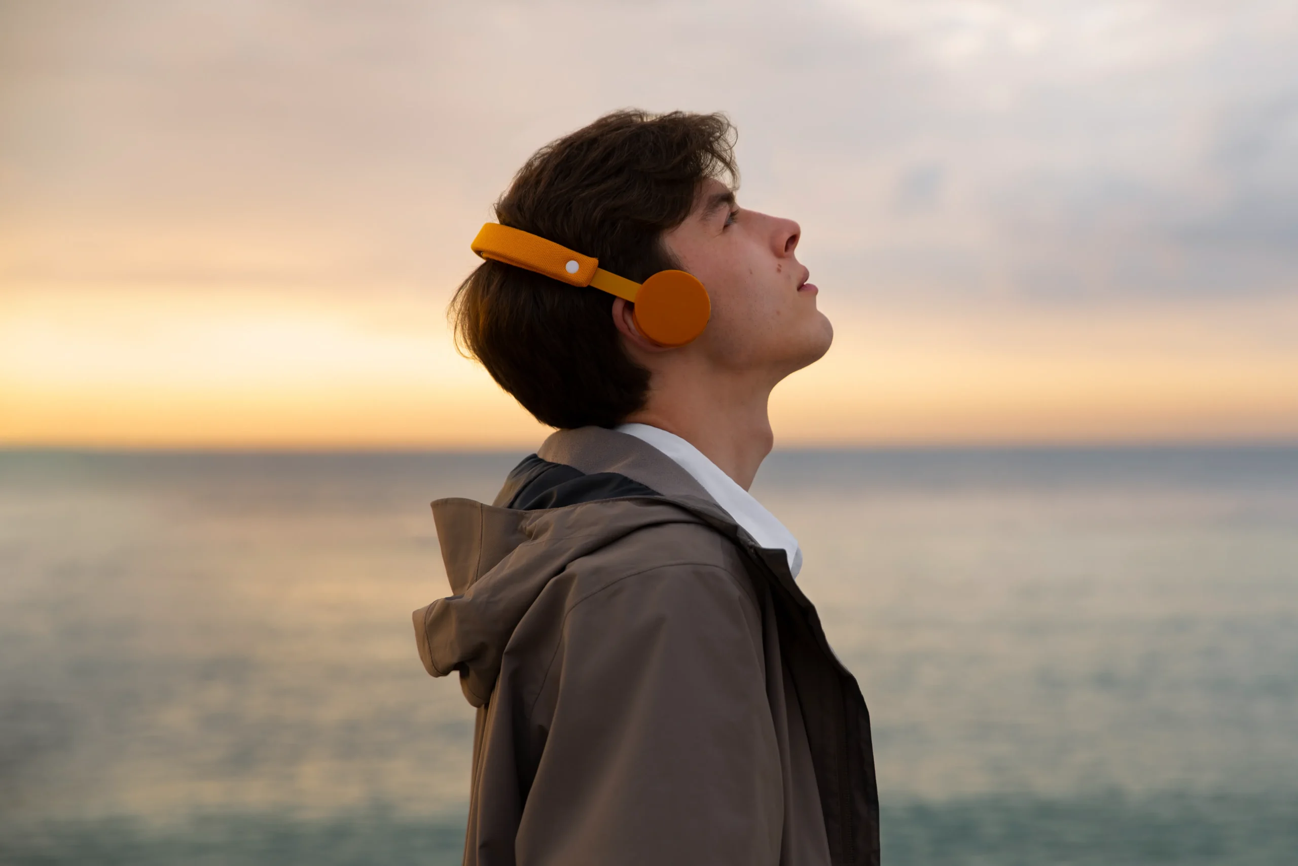 The Genius Wave: Young man listening to the sunset for mental clarity and inspiration